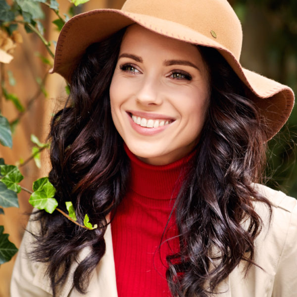 Portrait of fashionably dressed woman in autumn hat. Beauty concept